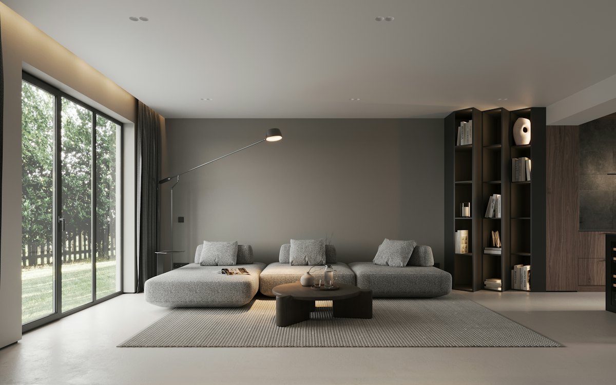 A calm, minimal living room with a low grey sofa and large windows
